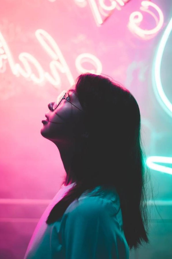 girl side profile in front of neon lights